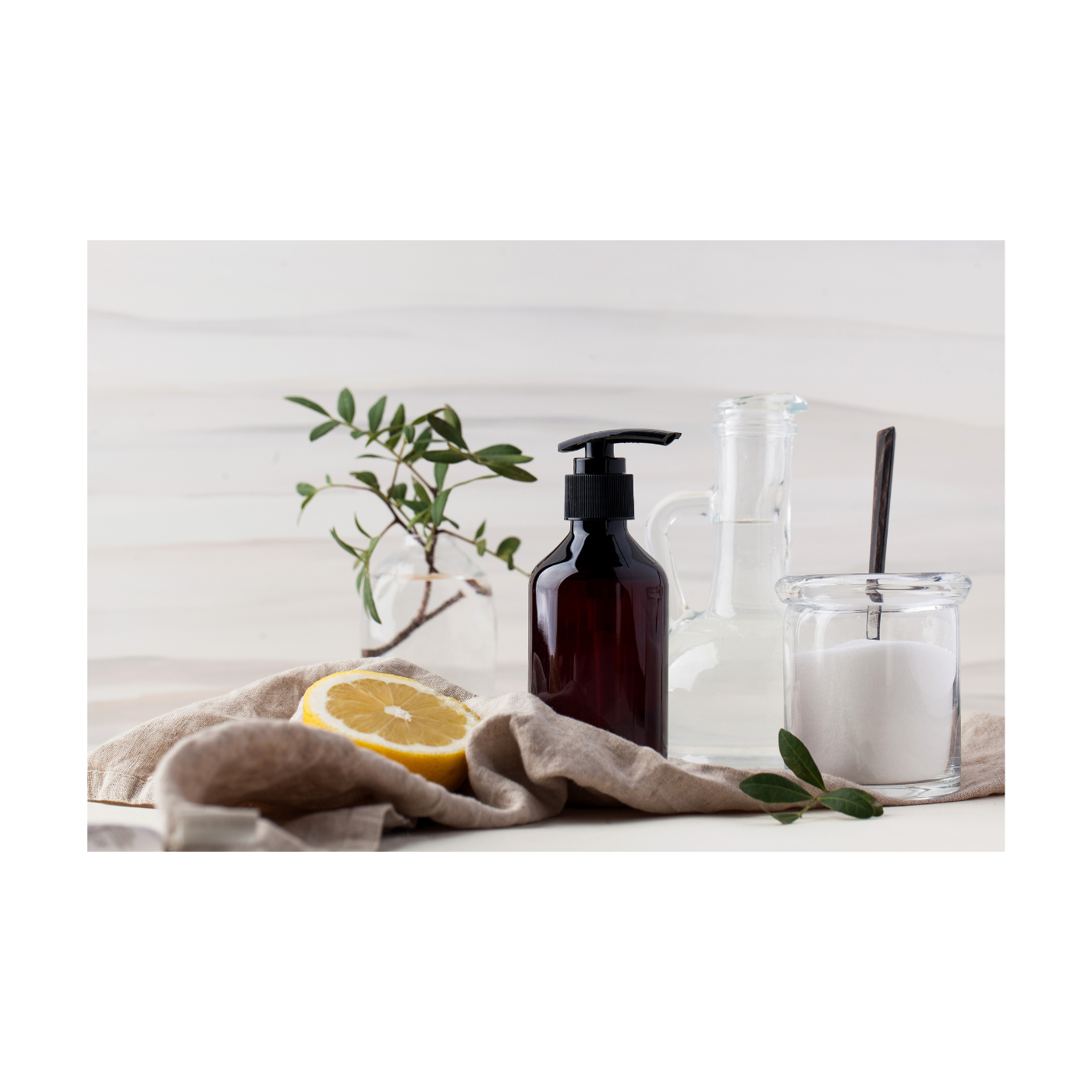 handmade floral room and linen spray, a glass golden bottle with a dropper, 2 white candles lit, background is blurred room 